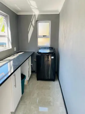 a small kitchen with a refrigerator in a room at Cozy Garden Facing Guest Suite -(Back up power) in Midrand