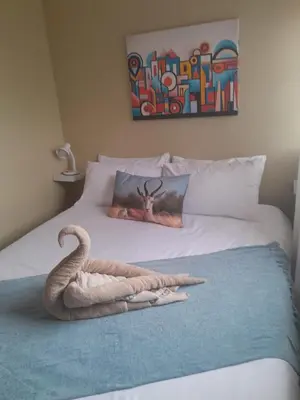 a bedroom with a bed with a swan on it at Kruger Bush Retreat in Marloth Park