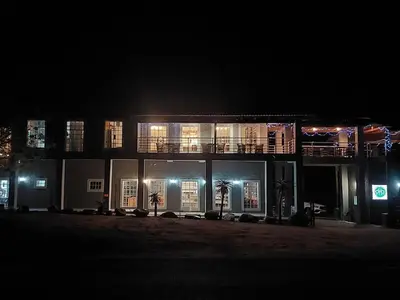 a lit up building at night with lights at @The Drakens Lodge in Hoedspruit