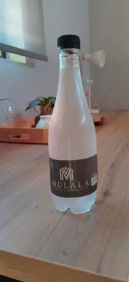 a bottle of milk on a wooden table at Mulala Luxury Guesthouse in Thohoyandou