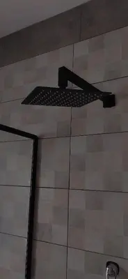 a shelf on the wall of a shower in a bathroom at Mulala Luxury Guesthouse in Thohoyandou