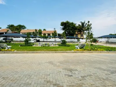 a park with benches and buildings in the background at Liams blue suite at 93 On New in Midrand