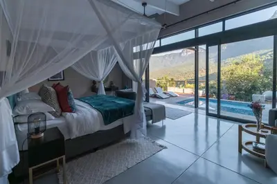 a bedroom with a bed and a swimming pool at Marepe Mountain View in Kampersrus AH