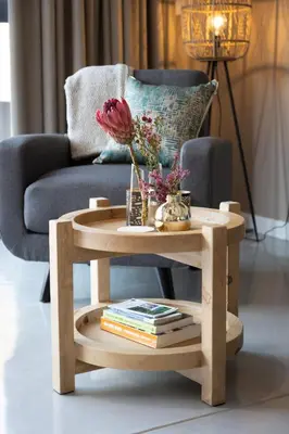 a wooden coffee table with a vase of flowers on it at Marepe Mountain View in Kampersrus AH