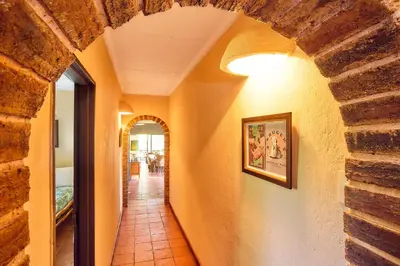 a hallway in a house with a brick wall at Parsons River Camp in Balule Game Reserve