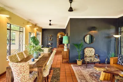 a living room with a table and chairs at Parsons River Camp in Balule Game Reserve