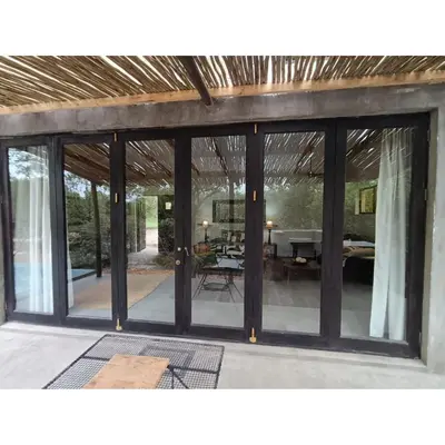 a room with sliding glass doors and a dining room at The Nest - Marloth Park in Marloth Park