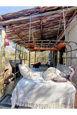 a bed on the back porch of a house at The Nest - Marloth Park in Marloth Park