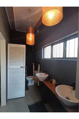 a bathroom with two sinks and two toilets at The Nest - Marloth Park in Marloth Park