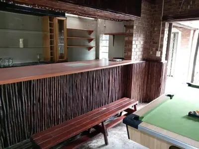 a bar with a bench and a pool table at KWR B&B in Witbank