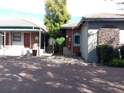 a house with a driveway in front of it at KWR B&B in Witbank