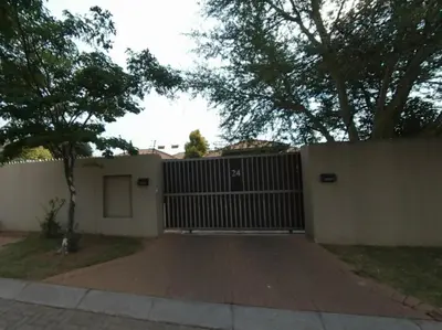 a house with a gate and a fence at KWR B&B in Witbank
