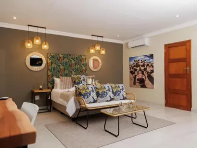 a living room with a bed and a couch at Lions View Accommodation in Nelspruit