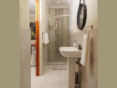 a bathroom with a sink and a shower at Lions View Accommodation in Nelspruit