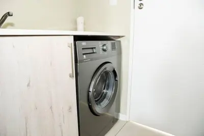 a washing machine in a kitchen next to a counter at Cozy Hidden gem in Midrand in Midrand