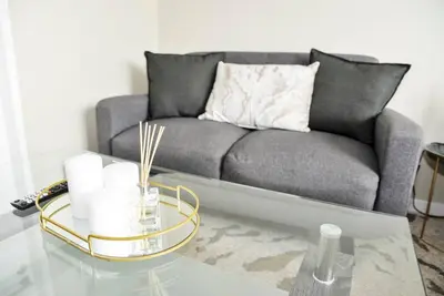 a living room with a couch and a glass table at Cozy Hidden gem in Midrand in Midrand