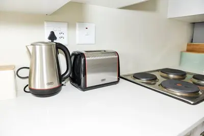 a toaster sitting on a kitchen counter next to a appliance at Cozy Hidden gem in Midrand in Midrand