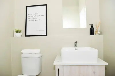 a bathroom with a white toilet and a sink at Cozy Hidden gem in Midrand in Midrand