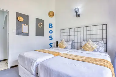 two twin beds in a bedroom with white walls at Modern Spanish House-3br-pool-solar-samrand in Centurion