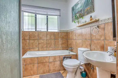 a bathroom with a tub and a toilet and a sink at Modern Spanish House-3br-pool-solar-samrand in Centurion