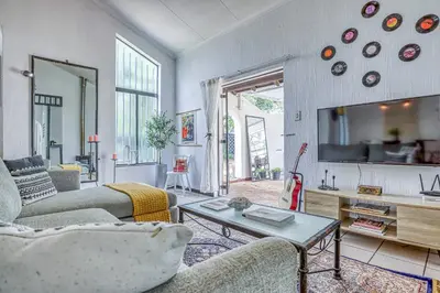 a living room with two couches and a tv at Modern Spanish House-3br-pool-solar-samrand in Centurion