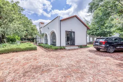 a car parked in front of a white house at Modern Spanish House-3br-pool-solar-samrand in Centurion