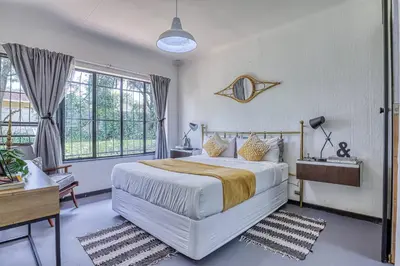 a bedroom with a large white bed and windows at Modern Spanish House-3br-pool-solar-samrand in Centurion