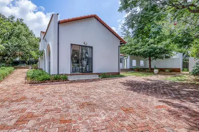 a brick driveway in front of a white house at Chic Midtown Studio-1 Bed-solar-pool-fibre-samrand in Centurion