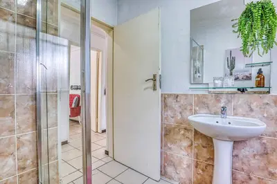 a bathroom with a sink and a shower at The Cottage-1 Bed-pool-bbq-fibre-solar-samrand in Centurion