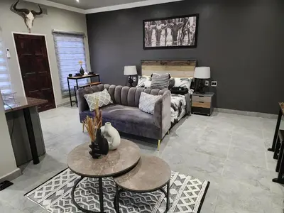 a living room with a couch and a table at South Gate Lodge in Polokwane