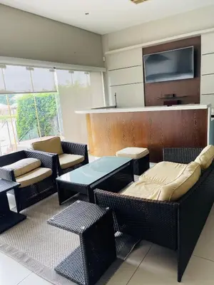 a room with chairs and a table and a tv at Lulanipho Abode in Hartbeespoort