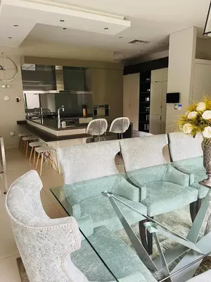 a living room with a glass table and chairs at Lulanipho Abode in Hartbeespoort