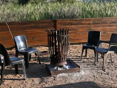 a group of chairs sitting in front of a fence at Ndi Musanda @ Nandoni in Vendaland
