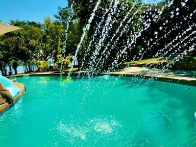 a fountain in the middle of a swimming pool at Ndi Musanda @ Nandoni in Vendaland