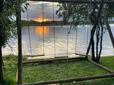 a swing in front of a lake with a sunset at Ndi Musanda @ Nandoni in Vendaland
