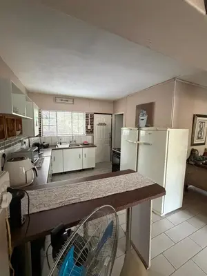 a kitchen with white appliances and a counter top at Babushka in Marloth Park