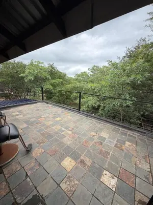 a view of a patio with trees in the background at Babushka in Marloth Park