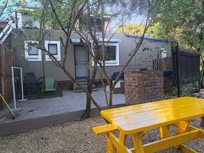 a wooden bench in front of a house at Babushka in Marloth Park
