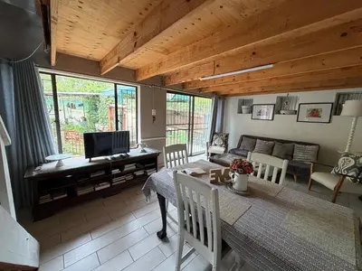 a living room with a dining table and a couch at Babushka in Marloth Park