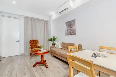 a living room with a couch and a table at Nosivu@Regency Apartment Hotel in Pretoria