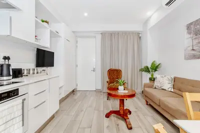 a living room with a couch and a table at Nosivu@Regency Apartment Hotel in Pretoria