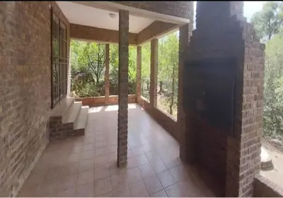 a screened in porch of a house with windows at Adder way around to Kruger in Marloth Park