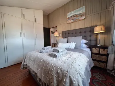 a bedroom with a bed with towels on it at Nyala Bush Cabin in Polokwane