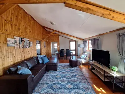 a living room with a couch and a tv at Nyala Bush Cabin in Polokwane