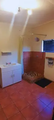 a bathroom with a tub and a sink in a room at A humble abode that is cozy in Centurion