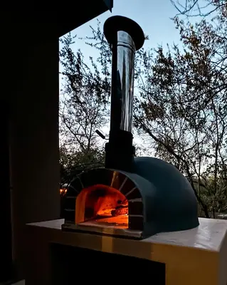 a brick oven sitting on top of a table at Shongololo Bush Villa in Marloth Park