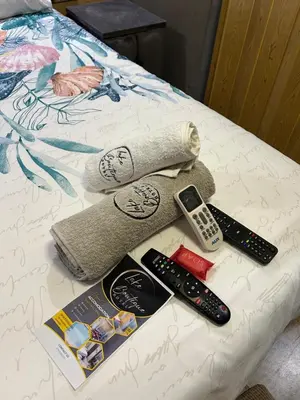 a group of remotes and remote controls on a bed at Lake Boutique Hotel in Thohoyandou