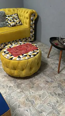 a yellow couch and a table in a living room at Lake Boutique Hotel in Thohoyandou
