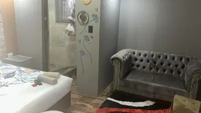 a living room with a couch and a shower at Lake Boutique Hotel in Thohoyandou