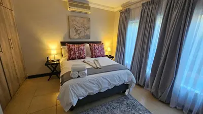 a bedroom with a bed with two towels on it at Grobler's Haven in Pretoria